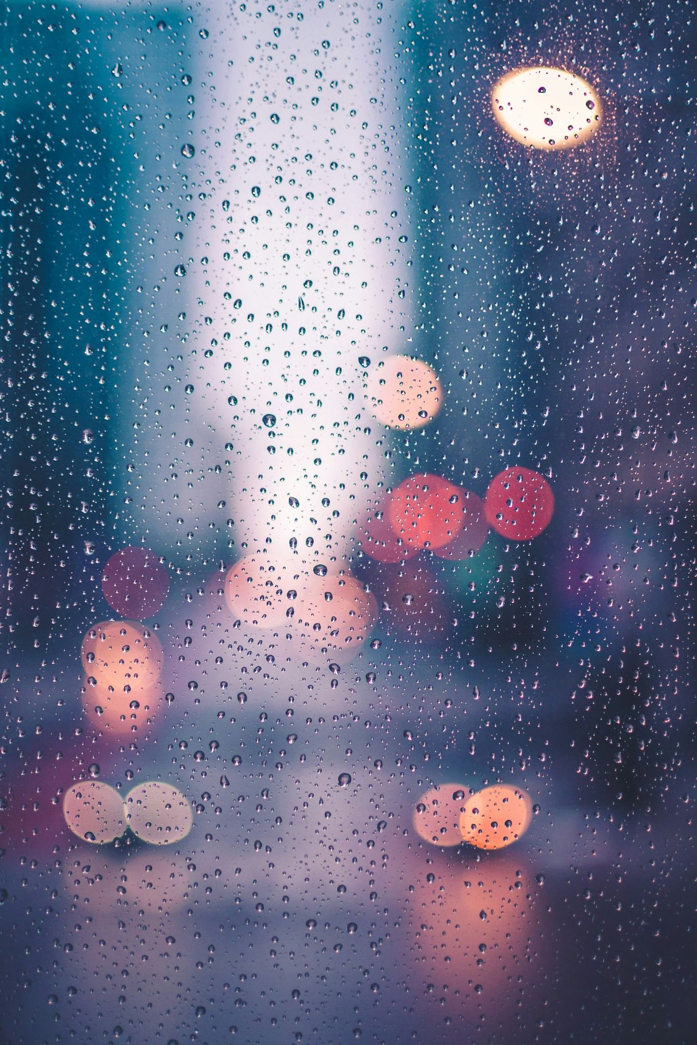 Rain streaming down a home window during a desert storm