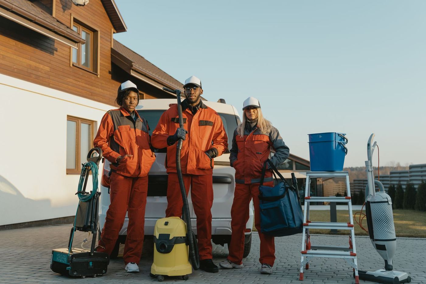 Restoration technicians in protective gear preparing equipment for a sewage cleanup job