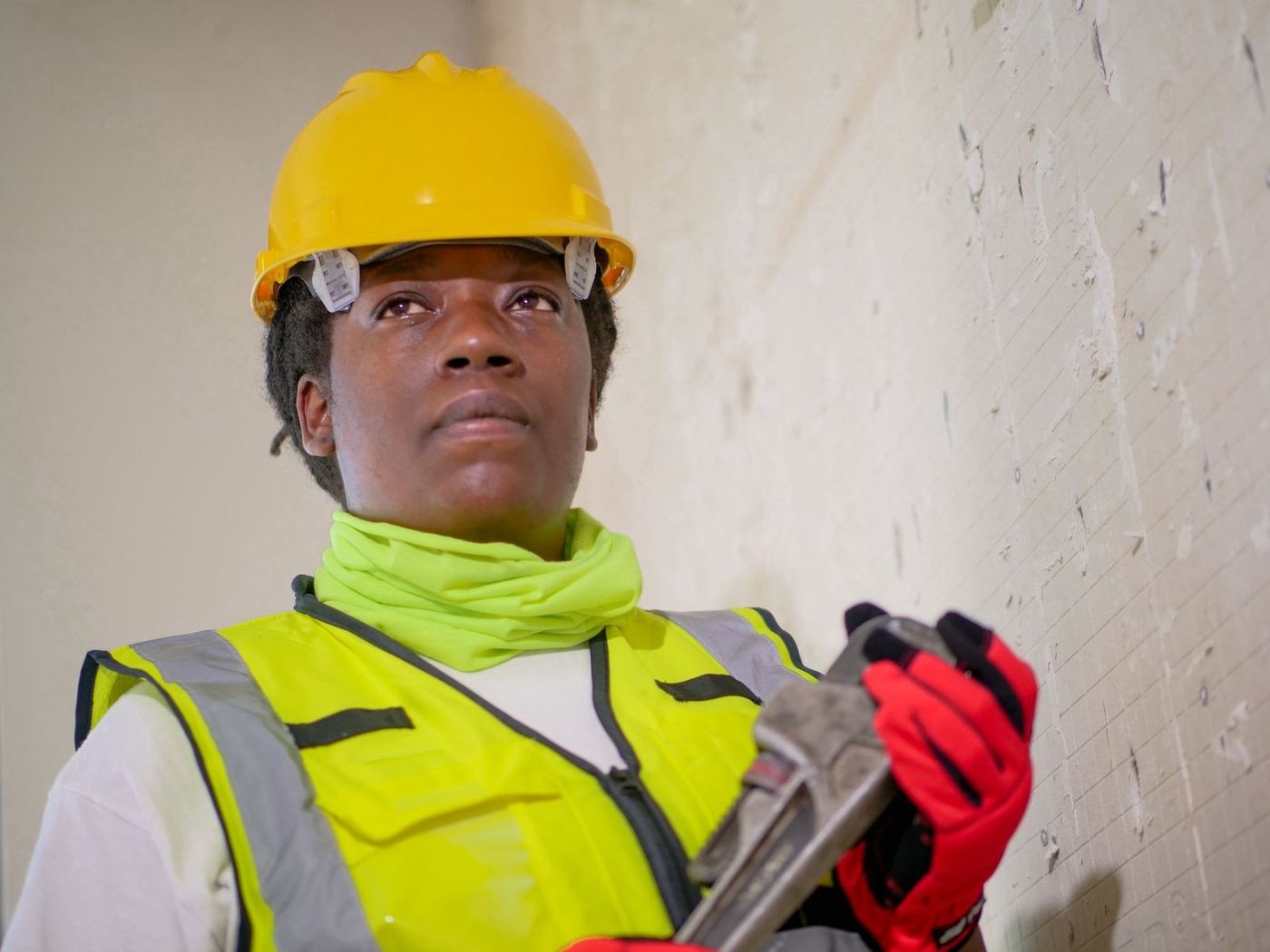 Friendly restoration technician in a high-visibility vest ready to help