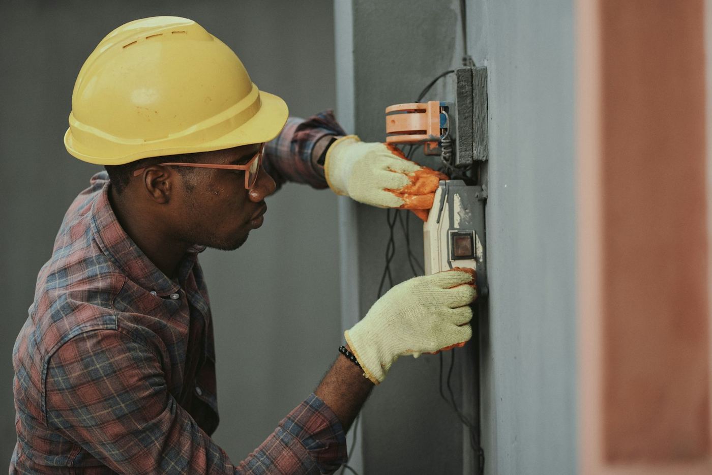 Contractor repairing water-damaged drywall in a home interior